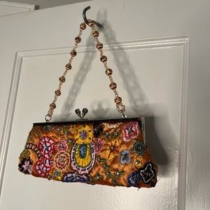 Multicolored clutch with beaded strap